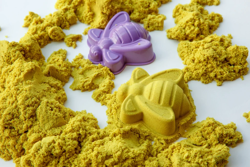 purple turtle mold with yellow kinetic sand casting